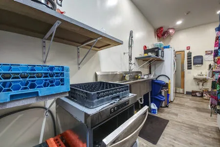 Kithen commercial triple sink and commercial dishwasher, 2 microwave ovens.