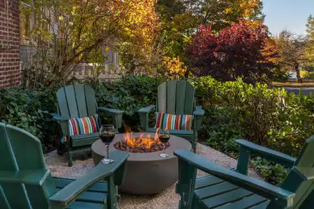 Professionally landscaped property w/ sprinkler system, cutting garden, fire pit