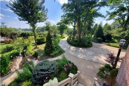 Expansive concrete driveway with parking lot for overnight guests